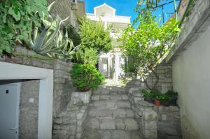 a stone walkway with plants on the side of a building at Apartments Milos Kaladjurdjevic in Budva