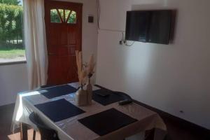 a room with a table and a television on a wall at departamento por día ruta 41 2 in Los Antiguos