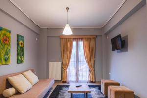 a living room with a couch and a window at Xenonas Drimos in Karpenisi