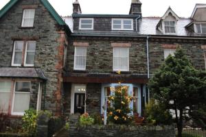 a brick house with a christmas tree in front of it at Bluestones in Keswick