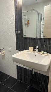 a bathroom with a white sink and a mirror at Drazn vrt in Kotor +5 photos
