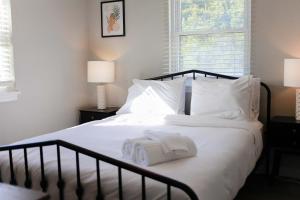 a bedroom with a bed with two towels on it at 1866 EOV Wave Suite in North Camellia Acres