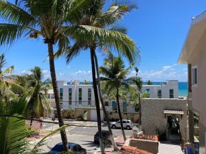 a view from the balcony of a building with palm trees at Pousada A Casa Portuguesa in Cabo de Santo Agostinho