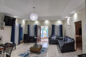 a living room with two couches and a table at St Thomas Oasis in Lyssons