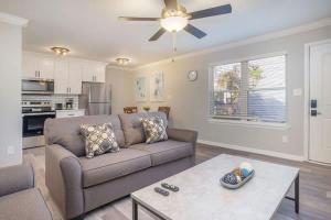 a living room with a couch and a table at Hillside Cove - Plank Suite in North Camellia Acres