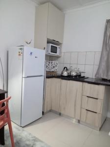 a kitchen with a white refrigerator and a microwave at Valleyview home Ixopo in Ixopo +7 photos