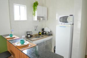 a small kitchen with a sink and a refrigerator at Flat encantador no Centro do Rio de Janeiro in Rio de Janeiro +9 photos