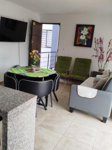 a living room with a table and a couch at Descanso cafetero apartasol Tebaida in La Tebaida +16 photos