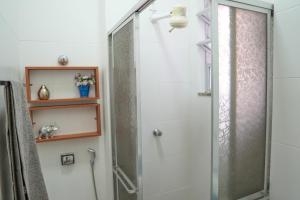 a shower with a glass door in a bathroom at Flat encantador no Centro do Rio de Janeiro in Rio de Janeiro