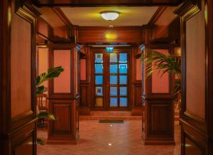 a hallway of a building with a door and a plant at Bark Inn - Bed and Breakfast in Braşov