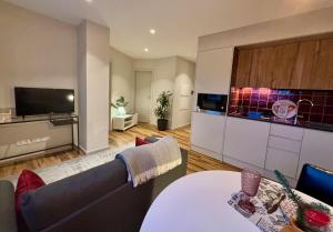 a living room with a couch and a table at Three Little Birds -RedBird in Guimarães