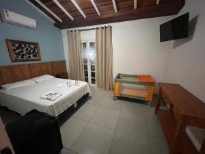 Postel nebo postele na pokoji v ubytování Pousada Portal de Paraty- COM GERADOR DE ENERGIA
