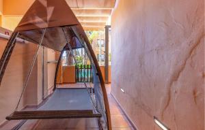 a room with a swing in a wall at Beautiful Apartment In Los Alcazares in Los Alcázares +14 photos
