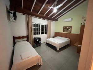 Postel nebo postele na pokoji v ubytování Pousada Portal de Paraty- COM GERADOR DE ENERGIA