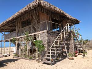 a small hut on the beach with a staircase at Lar Torus Eco Lodge - Kite is Surf in Tatajuba
