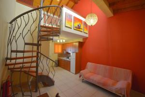 a living room with a spiral staircase and a couch at Megali Luxuries Apartments in Sidari