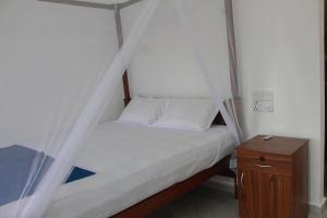 Postel nebo postele na pokoji v ubytování Shehara Sun Surf Lodge