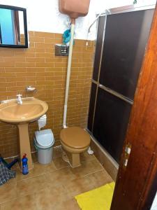 a bathroom with a toilet and a sink and a shower at Casa de Muriqui in Mangaratiba +11 photos