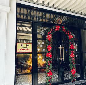 a store front with christmas decorations in the window at Sushi House Ba Dinh homestay alley38 Hang Bun in Hanoi
