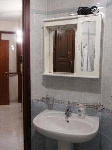 ein Bad mit einem Waschbecken und einem Spiegel in der Unterkunft L'Isola nel Mare in San Vito lo Capo
