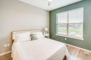 a bedroom with a white bed and a window at Close to Lakes and Museums Bonham Vacation Rental in Bonham