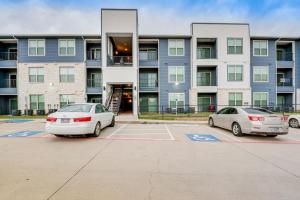 two cars parked in a parking lot in front of a building at Close to Lakes and Museums Bonham Vacation Rental in Bonham
