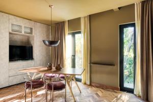 a dining room with a table and chairs and a television at El Alfonsa in Mexico City