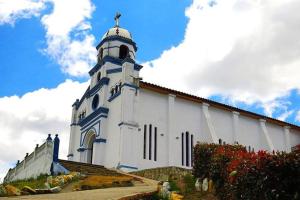 a white church with a tower on top of it at Habitación Privada Chia Centro Luna Serena in Chía