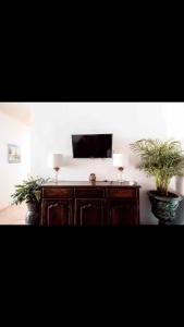 two potted plants sitting on top of a wooden cabinet at Casa Guijas in Guanajuato