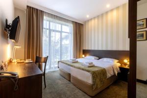 Postel nebo postele na pokoji v ubytování Citrus Hotel