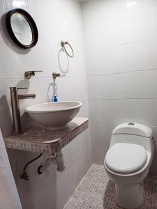 a bathroom with a sink and a toilet at Casa Victoria in San Cristóbal de Las Casas