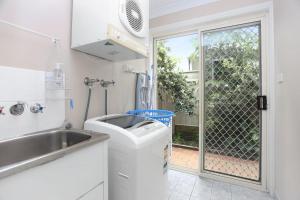 a small kitchen with a sink and a window at Aquarius Townhouse in Hawks Nest