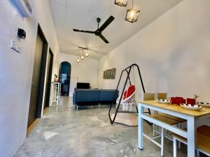 a living room with a ceiling fan and a table at Home41#6pax#netflix#NearIconCity&AeonAlma in Bukit Mertajam