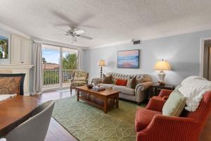 a living room with a couch and a table at King & Prince North Unit 379 in East End