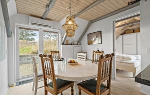 a dining room with a table and chairs and a bed at 3 Bedroom Beautiful Home In Ringkøbing in Ringkøbing