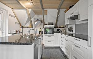 a kitchen with white cabinets and a sink at 3 Bedroom Beautiful Home In Ringkøbing in Ringkøbing