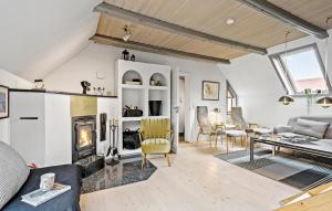 a living room with a fireplace and a couch at 3 Bedroom Beautiful Home In Ringkøbing in Ringkøbing