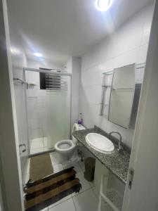 a bathroom with a toilet and a sink and a shower at Próx a praia in São Luís