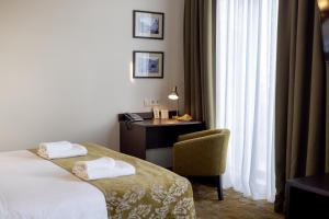 Postel nebo postele na pokoji v ubytování Citrus Hotel