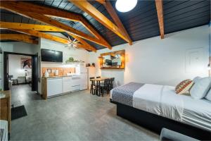 a bedroom with a king sized bed and a kitchen at Hansen Inn & Cabins in Wall
