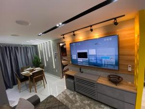 a living room with a large flat screen tv at Apartamento de luxo na Beira Mar in Fortaleza