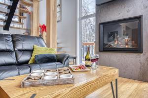 a living room with a couch and a table at Havre de Paix in Saint-Rémi-dʼAmherst