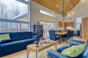 a living room with blue couches and a table at Havre de Paix in Saint-Rémi-dʼAmherst +71 photos