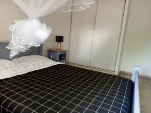 a bedroom with a bed with a black and white at Blue Side in Le Moule