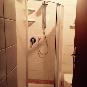 a shower with a glass door in a bathroom at Albergo Ristorante Valsugana in Primolano