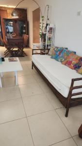 a couch sitting on a tiled floor in a living room at Aire de campo en la ciudad in San Fernando del Valle de Catamarca