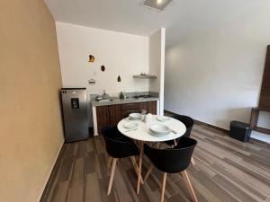 a dining room with a white table and chairs at Lofts Terra Nuevo Vallarta in Nuevo Vallarta