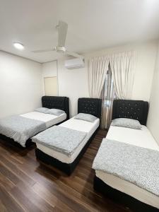 a room with three beds and a window at TuR15 SPlCE 10pax 4room Private House in Bayan Lepas +10 photos