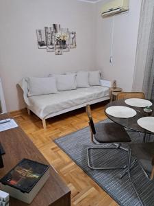 a living room with a couch and a table at Apartman Dream M Zaječar in Zaječar