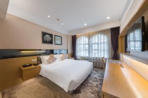 Postel nebo postele na pokoji v ubytování Shenzhen Shekou Honlux Apartment (Sea World) + 28 fotografií